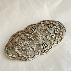 Finely chiseled silver brooch