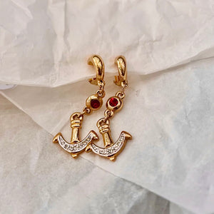 Anchor dangling earrings with small red stones