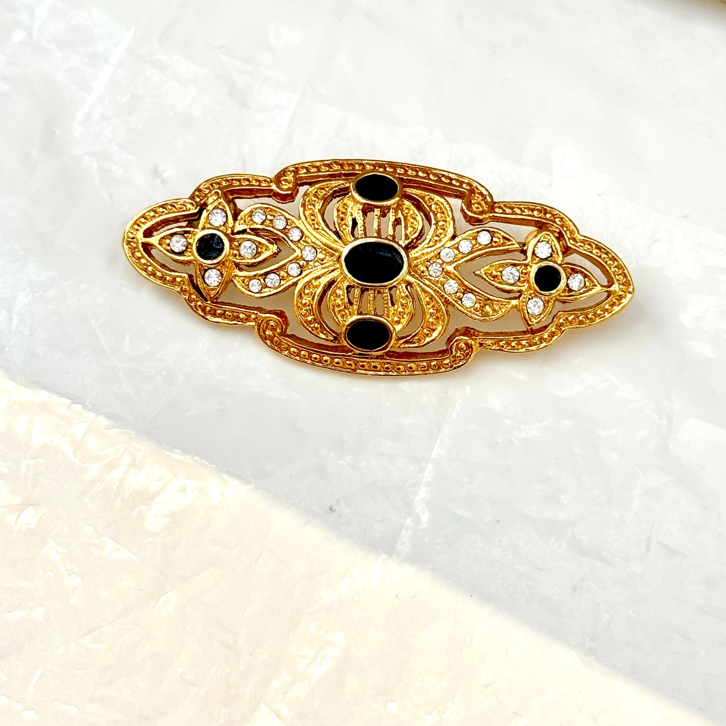 Gold and black brooch with detailed arabesques 2