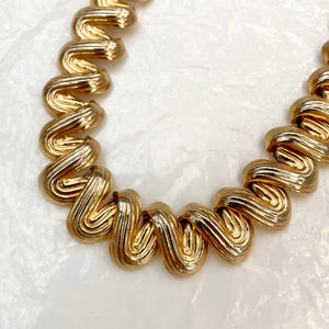 Perfectly patinated golden wave necklace