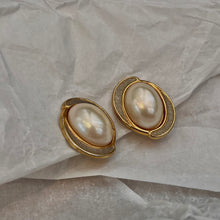 Load the image in the gallery, Pretty white pearl earrings circled in gold and silver