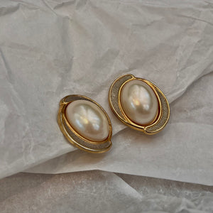Pretty white pearl earrings circled in gold and silver