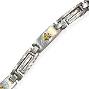Silver watch strap style bracelet with gold rudder