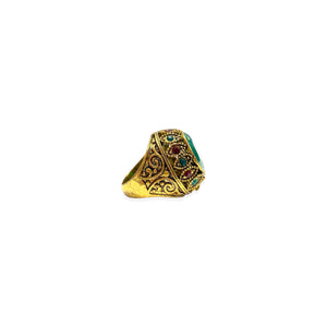 Large golden ring with green and red stones