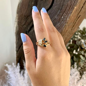 Asymmetrical golden ring with fake blue and white diamonds